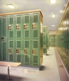 a row of green lockers in a room with tables and benches next to them