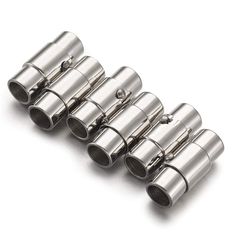 four stainless steel exhaust muffles on a white background