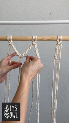 someone is making macrame shelf with rope