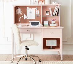 a pink desk with a laptop on top of it and a chair in front of it