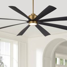 a ceiling fan with black blades in a room