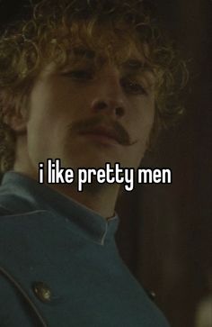 a man with curly hair is looking at the camera and says i like pretty men
