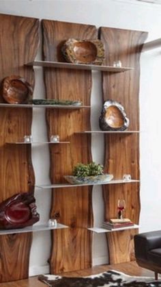 a living room filled with furniture and wooden shelves next to a cowhide rug on top of a hard wood floor