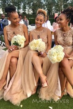 three bridesmaids sitting on the grass with their bouquets in front of them