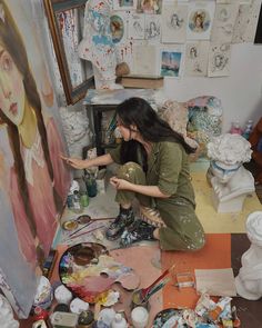 a woman is painting in an art studio