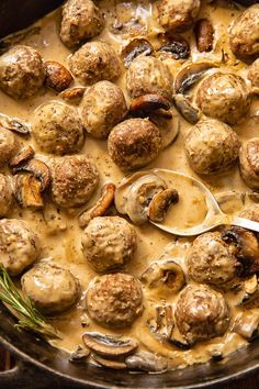 a pan filled with meatballs covered in gravy