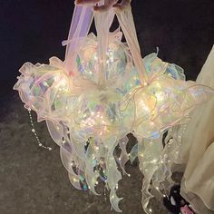a chandelier hanging from the ceiling with lights in it's centerpiece