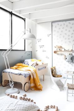 a child's bedroom with white walls and flooring is decorated in neutral colors