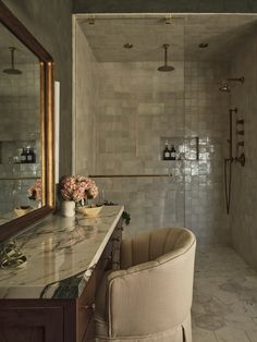 a bath room with a tub a sink and a mirror on the wall next to a chair