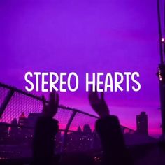the words stereo hearts are in front of a purple background with silhouettes of people raising their hands