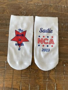 two white socks with red, white and blue stars that say the work is nca