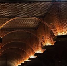 the lights are shining on the ceiling in the subway car tunnel, which is lined with rows of benches