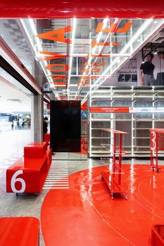 the inside of a store with red furniture