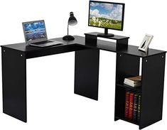 a computer desk with a laptop and monitor on it, sitting in front of a bookshelf