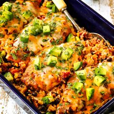 a casserole dish with meat, rice and vegetables