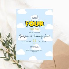 a blue and yellow four year birthday party card on top of a white tablecloth