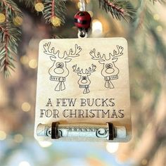 a wooden ornament hanging from a christmas tree with reindeers and snowflakes on it