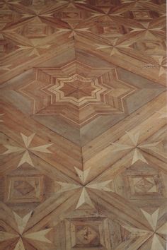 the floor is made up of wood and has star designs on it