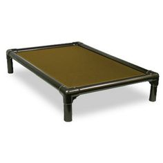 the bed frame is made out of metal and has a brown sheet on top of it