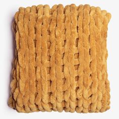 a square pillow made out of brown fuzzy material