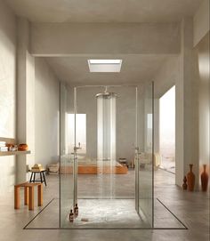 a bathroom with a large shower and two stools