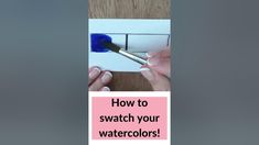 a person using a paint brush to fix a watercolor on paper with the words how to swatch your watercolors