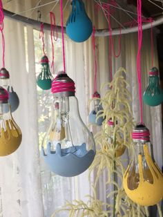 colorful light bulbs hanging from a ceiling