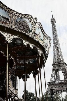 the eiffel tower is reflected in the windows of this carousel