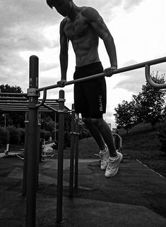 a man standing on top of a metal bar