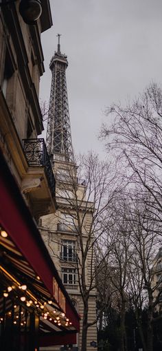 the eiffel tower is in the distance behind some buildings