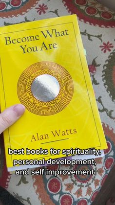 a person holding up a book with the title, become what you are best books for spirituality personal development and self improvement