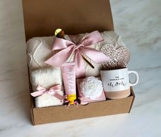 a gift box filled with coffee, marshmallows, and other personal care items