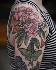 a woman with a flower and butterfly tattoo on her arm