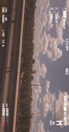 an overhead view of the sky with clouds and trees on either side of the road