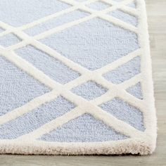 a blue and white rug on top of a wooden floor