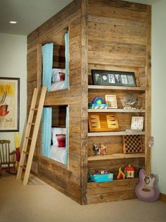 there is a bunk bed built into the side of a wall with bookshelves and ladders