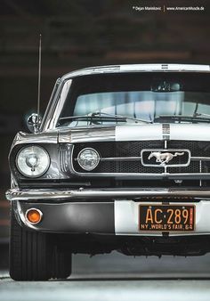 the front end of an old mustang car with a number plate on it's bumper