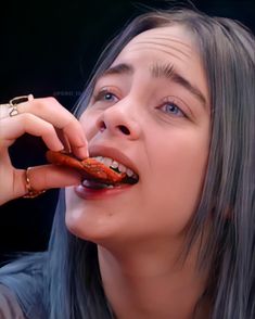 a woman with grey hair is eating something