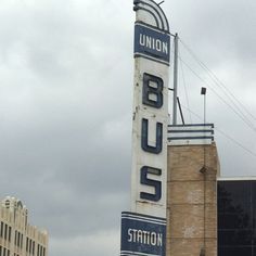 the union bus station sign is in front of some tall buildings on a cloudy day