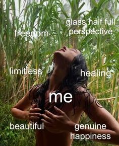 a woman with her eyes closed standing in front of some tall grass and looking up at the sky