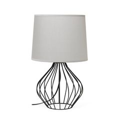 a table lamp with a white shade on top and black wire design around the base