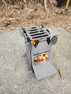 a fire pit sitting on top of a cement ground