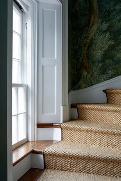 an image of some stairs going up to the room that is decorated with wallpaper