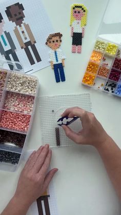a person is working on some crafting with legos and other things in the background