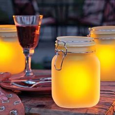 mason jars filled with liquid sitting on top of a wooden table