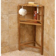 a wooden shelf with soap, shampoo and other items on it in a tiled bathroom