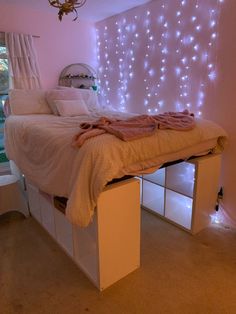 a bedroom with lights on the wall and a bed in it's centerpiece