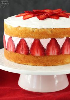 a cake with white frosting and strawberries on top