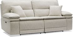 the reclining sofa has two pillows on it's back and is facing away from the