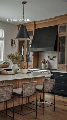 a large kitchen with wooden cabinets and white counter tops is pictured in this image, there are four chairs at the center of the island